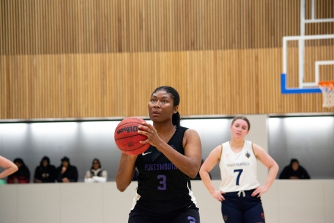 Student plaing basketball